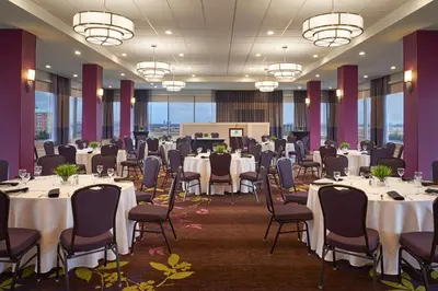 a conference room with tables and chairs and tablesktop at Holiday Inn Toronto International Airport by IHG in Toronto