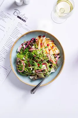 a plate of food with a salad on a table at Holiday Inn Toronto International Airport by IHG in Toronto