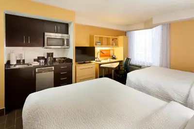 a hotel room with two beds and a kitchen at TownePlace Suites by Marriott Toronto Northeast/Markham in Markham