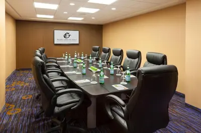 a conference room with a long table and black chairs at TownePlace Suites by Marriott Toronto Northeast/Markham in Markham