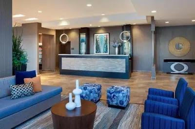 a lobby with a blue couch and blue chairs at TownePlace Suites by Marriott Toronto Northeast/Markham in Markham