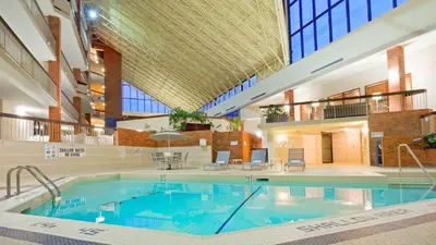 a large swimming pool in a large building at Holiday Inn Oakville Centre by IHG in Oakville