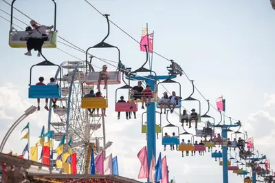 a group of people riding a roller coaster at a carnival at Holiday Inn Oakville Centre by IHG in Oakville