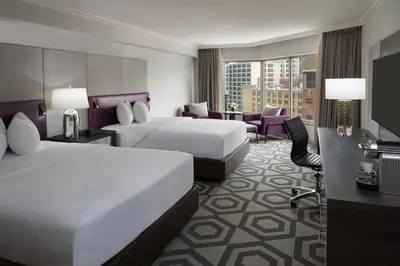 a hotel room with two beds and a television at InterContinental Toronto Centre by IHG in Toronto