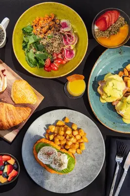 a table topped with plates of food and bowls of food at InterContinental Toronto Centre by IHG in Toronto