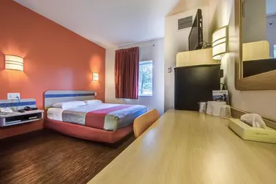 a hotel room with a bed and a desk at Motel 6-Burlington, ON - Toronto West - Oakville in Burlington