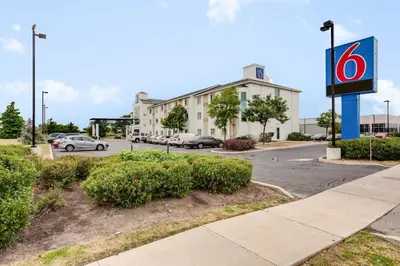 a building with a sign in front of a parking lot at Motel 6-Brampton, ON - Toronto in Brampton