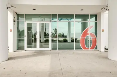 an entrance to a building with a large glass door at Motel 6-Brampton, ON - Toronto in Brampton