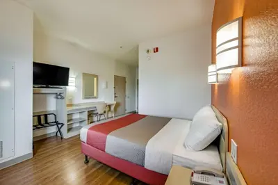 a hotel room with a bed and a desk at Motel 6-Brampton, ON - Toronto in Brampton