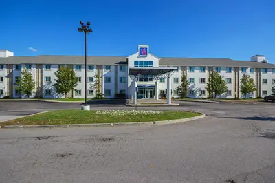 an empty parking lot in front of a large building at Motel 6-Whitby, ON - Toronto East in Whitby