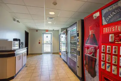 a hallway of a fast food restaurant with a soda machine at Motel 6-Whitby, ON - Toronto East in Whitby