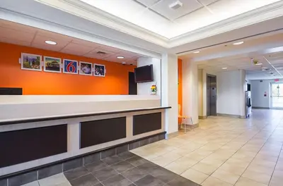 a lobby of a hospital with an orange wall at Motel 6-Whitby, ON - Toronto East in Whitby