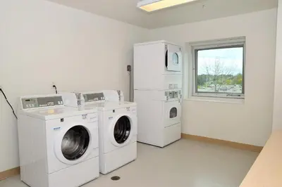 a laundry room with a washer and dryer and a window at Motel 6-Whitby, ON - Toronto East in Whitby