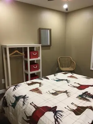 a bedroom with a bed with a spider design on it at The Village Suites in Wellington