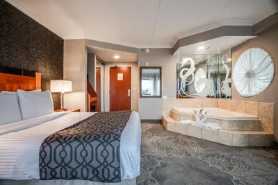 a hotel room with a bed and a tub at Monte Carlo Inn Barrie - Newly Renovated in Barrie