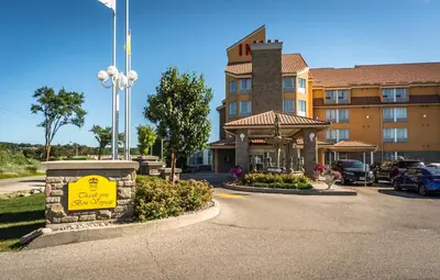 a hotel with a yellow sign in front of a building at Monte Carlo Inn Barrie - Newly Renovated in Barrie