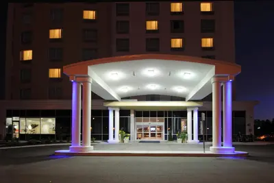 a large building with purple lights in front of it at Holiday Inn Express Hotel & Suites Toronto - Markham by IHG in Richmond Hill