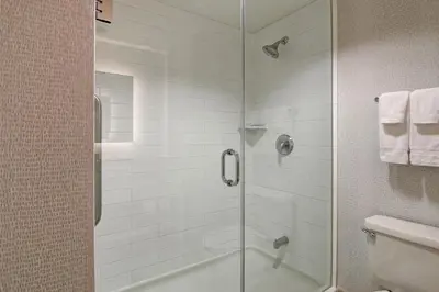 a shower with a glass door in a bathroom at Holiday Inn Express Hotel & Suites Toronto - Markham by IHG in Richmond Hill