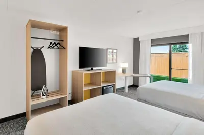 a hotel room with two beds and a flat screen tv at Spark By Hilton Toronto Markham in Markham