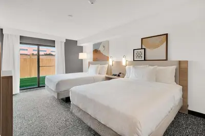 a hotel room with two beds and a window at Spark By Hilton Toronto Markham in Markham