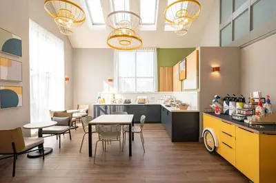 a kitchen with a table and chairs in a room at Spark By Hilton Toronto Markham in Markham