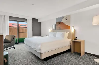 a hotel room with a bed and a chair at Spark By Hilton Toronto Markham in Markham