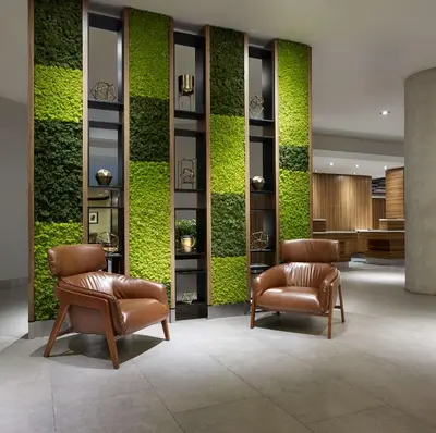 a lobby with two chairs and a green wall at Hilton Garden Inn Toronto Airport in Mississauga