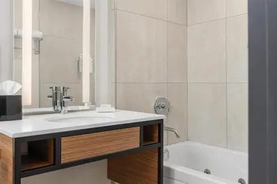 a bathroom with a sink and a bath tub at Hilton Garden Inn Toronto Airport in Mississauga