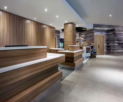 a lobby with wooden walls and stairs in a store at Hilton Garden Inn Toronto Airport in Mississauga