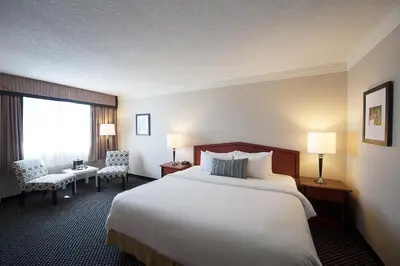 a hotel room with a large bed and a window at Toronto Don Valley Hotel and Suites in Toronto