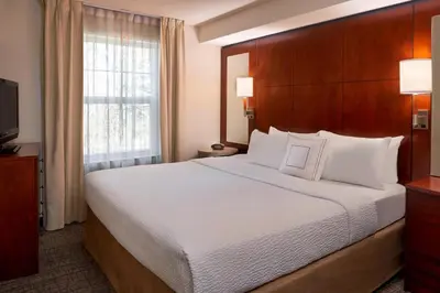 a hotel room with a large bed and a window at Residence Inn by Marriott Gravenhurst Muskoka Wharf in Gravenhurst