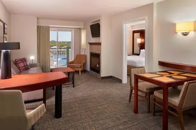 a hotel room with a living area and a bedroom at Residence Inn by Marriott Gravenhurst Muskoka Wharf in Gravenhurst