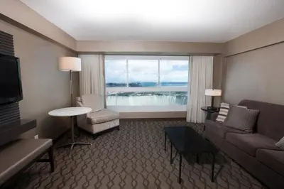 a living room with a couch and chairs and a window at Niagara Falls Marriott Fallsview Hotel & Spa in Niagara Falls