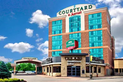 a tall building with a sign on top of it at Courtyard by Marriott Niagara Falls in Niagara Falls