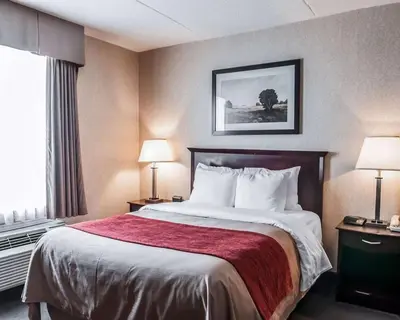 a hotel room with a bed and a window at Comfort Inn in Mississauga