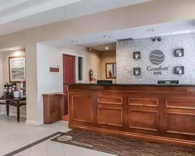 a lobby with a dental office with a reception desk at Comfort Inn in Mississauga