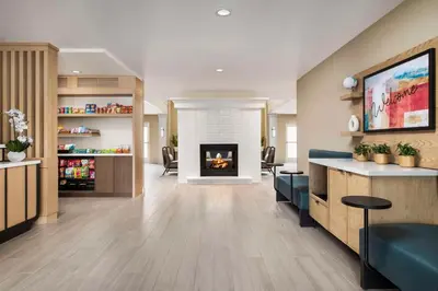 a living room with a fireplace in a building at Sonesta ES Suites Toronto Markham in Markham