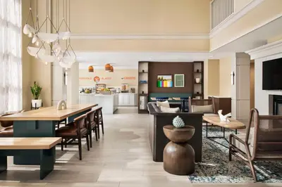 a dining room and kitchen with tables and chairs at Sonesta ES Suites Toronto Markham in Markham