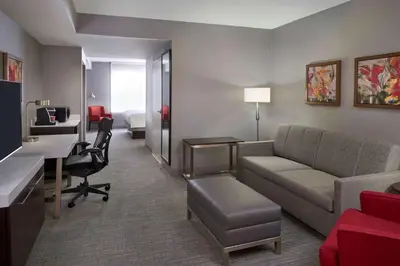 a hotel room with a couch and a desk at Hilton Garden Inn Toronto Airport West/Mississauga in Mississauga