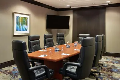 a conference room with a wooden table and chairs at Hilton Garden Inn Toronto Airport West/Mississauga in Mississauga