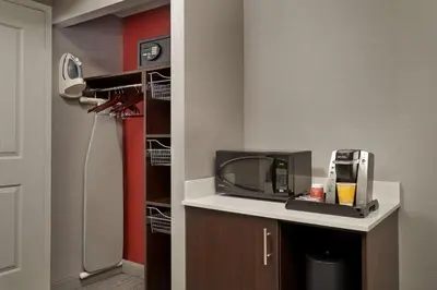 a kitchen with a refrigerator and a tv on a counter at Hilton Garden Inn Toronto Airport West/Mississauga in Mississauga