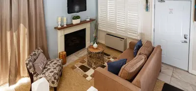 a living room with two couches and a fireplace at Condo Loft at Blue Mountain in Blue Mountains