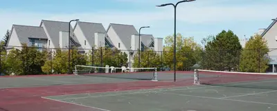 a tennis court with a net in front of a building at Condo Loft at Blue Mountain in Blue Mountains