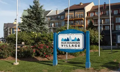 a sign for a ridge mountain village in front of a building at Condo Loft at Blue Mountain in Blue Mountains