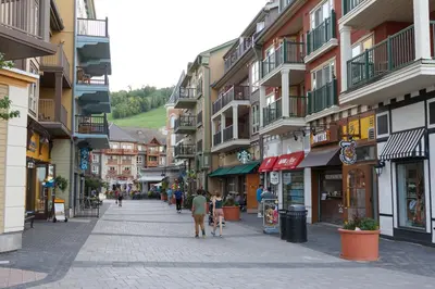 a street in a town with people walking down the street at Condo Loft at Blue Mountain in Blue Mountains
