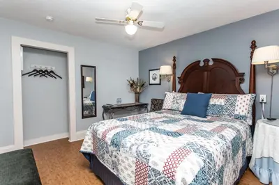 a bedroom with a bed and a ceiling fan at Ambiance By The Falls B&B in Niagara Falls