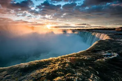 a view of a waterfall at sunset at Ambiance By The Falls B&B in Niagara Falls