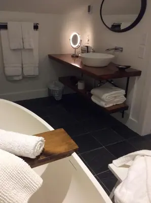 a bathroom with a sink and a mirror at Woodbourne Inn in Niagara on the Lake
