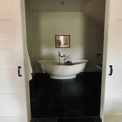 a bathroom with a large white tub in a room at Woodbourne Inn in Niagara on the Lake