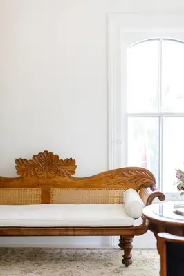 a wooden bench sitting in a room with a window at Woodbourne Inn in Niagara on the Lake